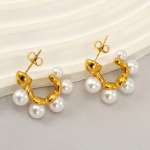French vintage wavy gold earrings with freshwater pearls on a white display stand