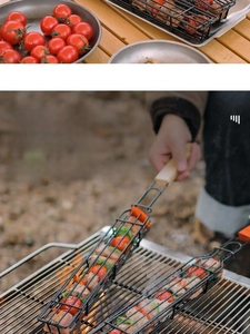 BBQ grilling basket with wooden handle filled with fresh vegetables and meat on grill