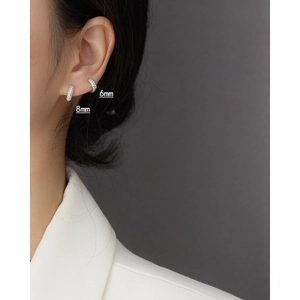 Detail showing 6mm and 8mm S925 silver hoop earrings with triple row zircon on ears