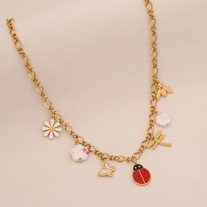 Detailed view of gold necklace with charms including daisy, butterfly, and ladybug charms