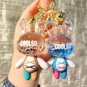 Detail of acrylic liquid quicksand rabbit keychains with gold bells and star sequins