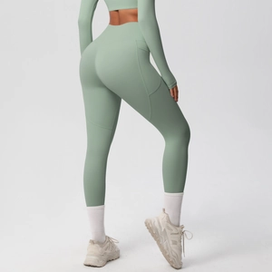 Sage green high-waisted yoga leggings detail showing side pocket and butt-lifting seam