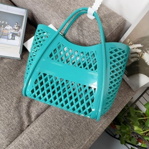 Close-up of mint green hollow mesh jelly basket bag on a sofa in a home lifestyle setting