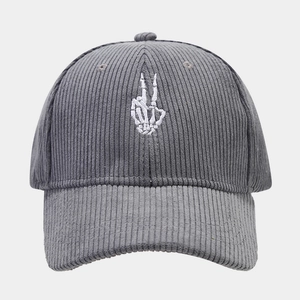 Detailed view of grey corduroy baseball cap with white bone gesture embroidery