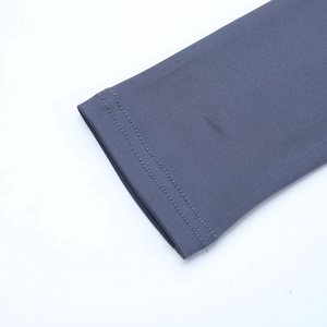 Detail of double-needle stitching and ribbed knit texture on a dark blue-gray dress