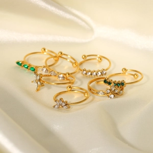 18K gold-plated open rings set with zircons and butterfly floral motifs on beige silk
