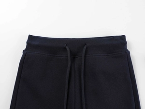 Detail view of high-waist yoga shorts with navy blue drawstring and elastic waistband