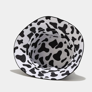 Reversible cow print bucket hat with smiley face for sun protection and outdoor casual style
