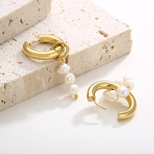 Detail of vintage gold pearl hoop earrings featuring three irregular freshwater pearls on stone