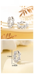 Detailed view of silver star hoop earrings with clear zircons and 1.5cm dimensions