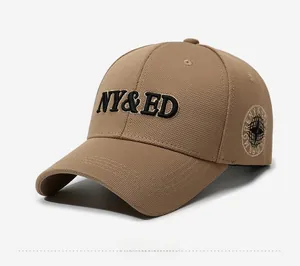 Detailed side view of khaki baseball cap featuring NY&ED embroidery and round globe patch