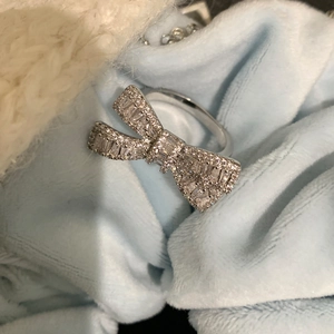 Macro shot of silver bow ring featuring detailed zircon inlay and sparkling craftsmanship