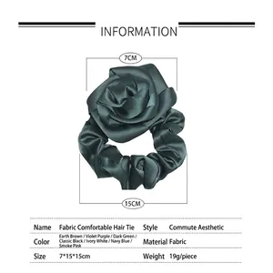 Dark green silk-textured fabric scrunchie in rose flower shape with dimensions shown