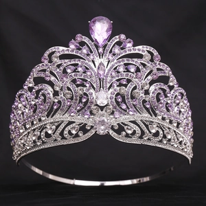 Detail of luxury pageant crown with purple and white crystals on silver metal base