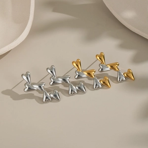 Two-tone heart stud earrings in gold and silver stainless steel minimalist style