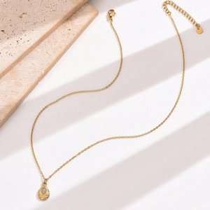 Elegant gold-tone stainless steel necklace featuring a teardrop pendant with shell inlay