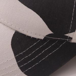 Detailed macro view of cow print baseball cap stitching and durable twill fabric