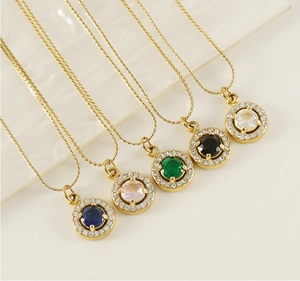 Detailed view of colorful round zircon pendants on golden stainless steel necklaces