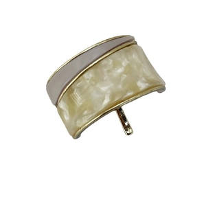 Minimalist wide hair cuff with marble resin and golden metal trim on white background