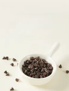 Macro view of realistic chocolate cone models in a white ceramic bowl for DIY crafts