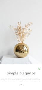 Detail of a spherical gold electroplated ceramic vase with a high-shine mirror finish