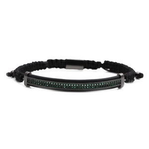 Detailed shot of woven bracelet with green zircon micro-pave in black titanium metal tube