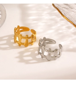 Detailed view of 18K gold and silver hollow geometric rings with fence pattern design
