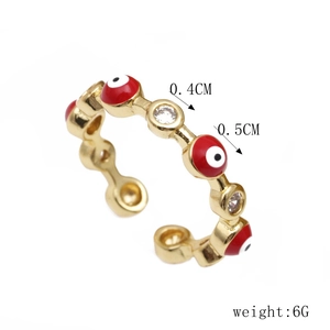 Detail shot of golden evil eye ring showing 0.4cm width and sparkling zircon accents