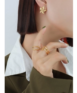 Detailed view of 18k gold plated flower petal earrings and geometric hollow rings