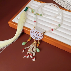Detail of beaded lock necklace with Xi character, silk tassel and green drop charms