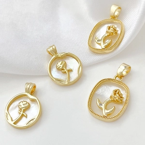 Macro shot of 18k gold plated rose pendants with white mother of pearl inlay detail