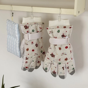 Detail of winter ski gloves with festive Christmas patterns and adjustable wrist straps