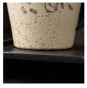 Detailed macro view of the ceramic mug's smooth flat base and rustic clay texture