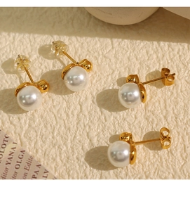 Detailed macro shot of white pearl earrings with gold hardware and two types of backings