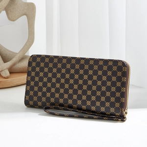 Brown long zipper wallet with gold clover pattern and matching wristlet strap