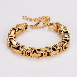 Macro detail of high-polish gold interlocking rectangular link bracelet with lobster clasp