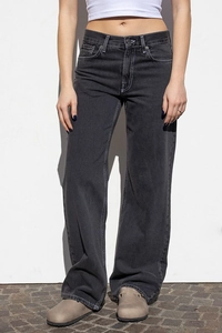 Close-up detail of high-waist straight-leg denim jeans with vintage washed texture