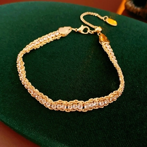 Detail of adjustable gold chain bracelet with sparkling round-cut clear zircons on velvet