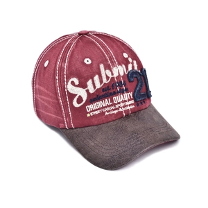 Detailed close-up of vintage distressed embroidery on wine red baseball cap with brown brim