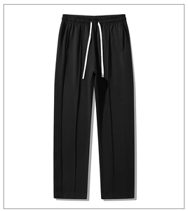 Detail of men's casual sweatpants featuring an adjustable elastic waist and white drawstring