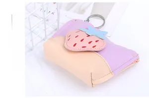Macro shot of strawberry mini pouch with metal ring clip on textured PU leather material