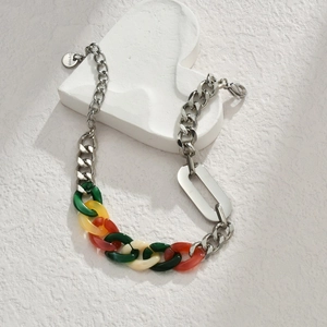 Detail of colorful acrylic links joined with a gold stainless steel chain and clasp