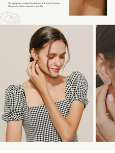 Detail view of light blue Hamsa hand stud earrings worn by a model in a minimal style