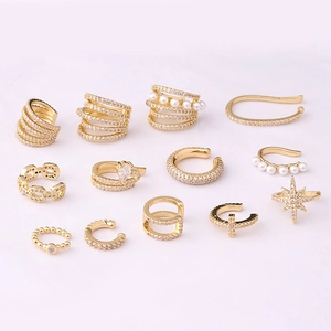 Set of 12 gold plated clip-on earrings with pavé zircons and pearls on pink background