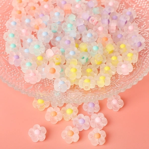 Frosted acrylic flower beads in various colors displayed in a glass tray for DIY jewelry