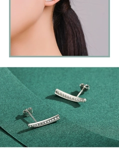 Close-up of elegant curved S925 sterling silver stud earrings with sparkling pavé crystals