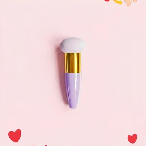 Detail view of angled teardrop makeup sponge brush with gold ferrule and purple handle