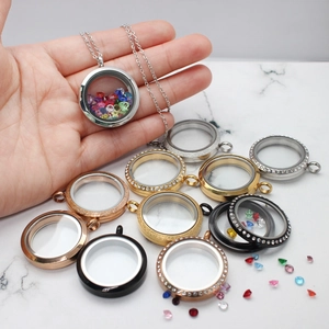 Detailed view of round glass locket pendants in various metal colors with crystal fillings