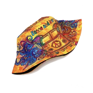 Close-up of yellow hippie sun hat with Peace and Love prints and mandala patterns