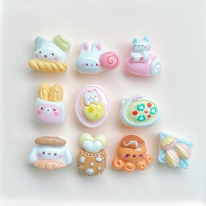 Flat lay of colorful resin DIY accessories in cartoon bear and dessert shapes